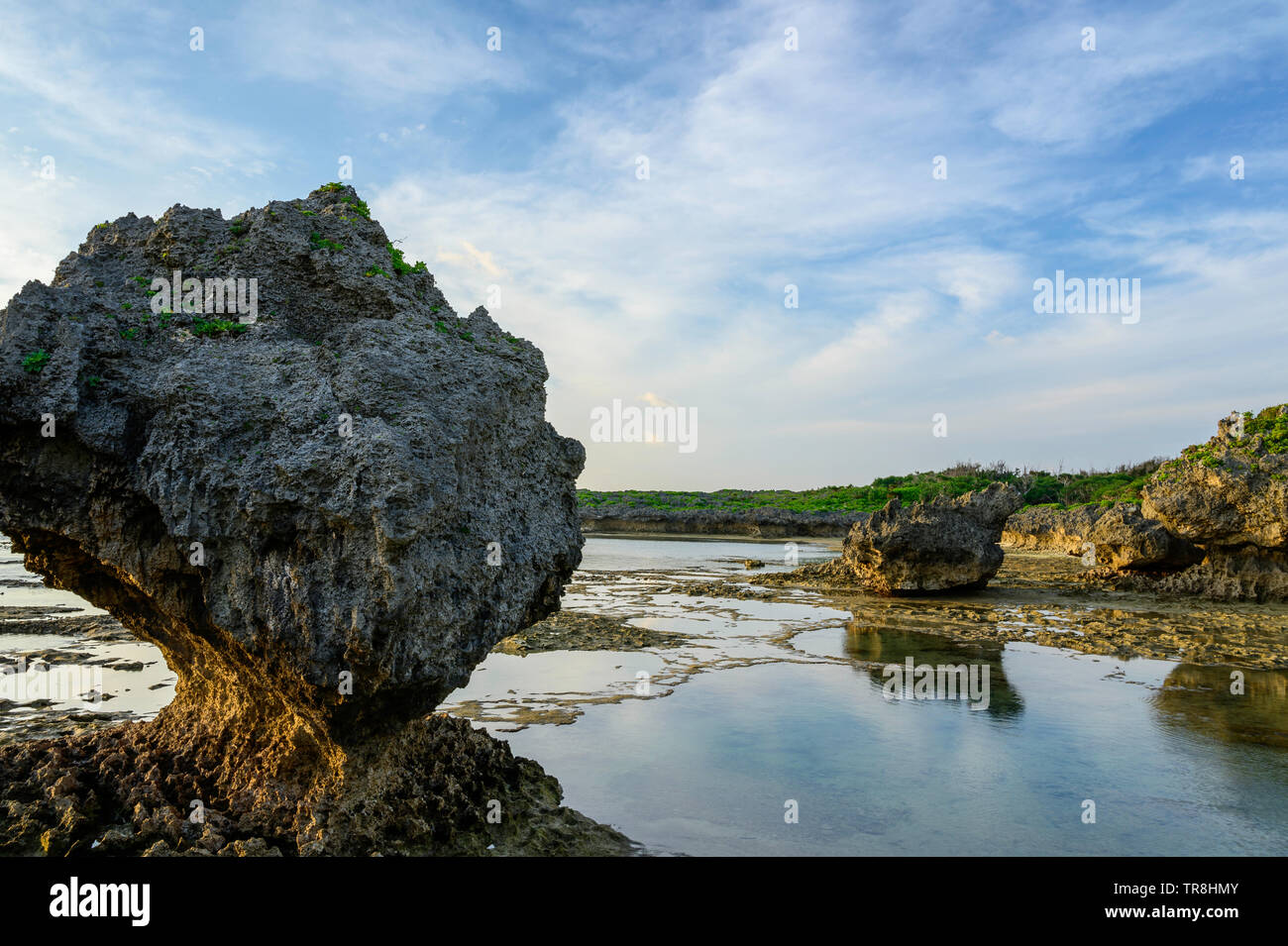 Sunset beach view with a heart shaped rock Stock Photo