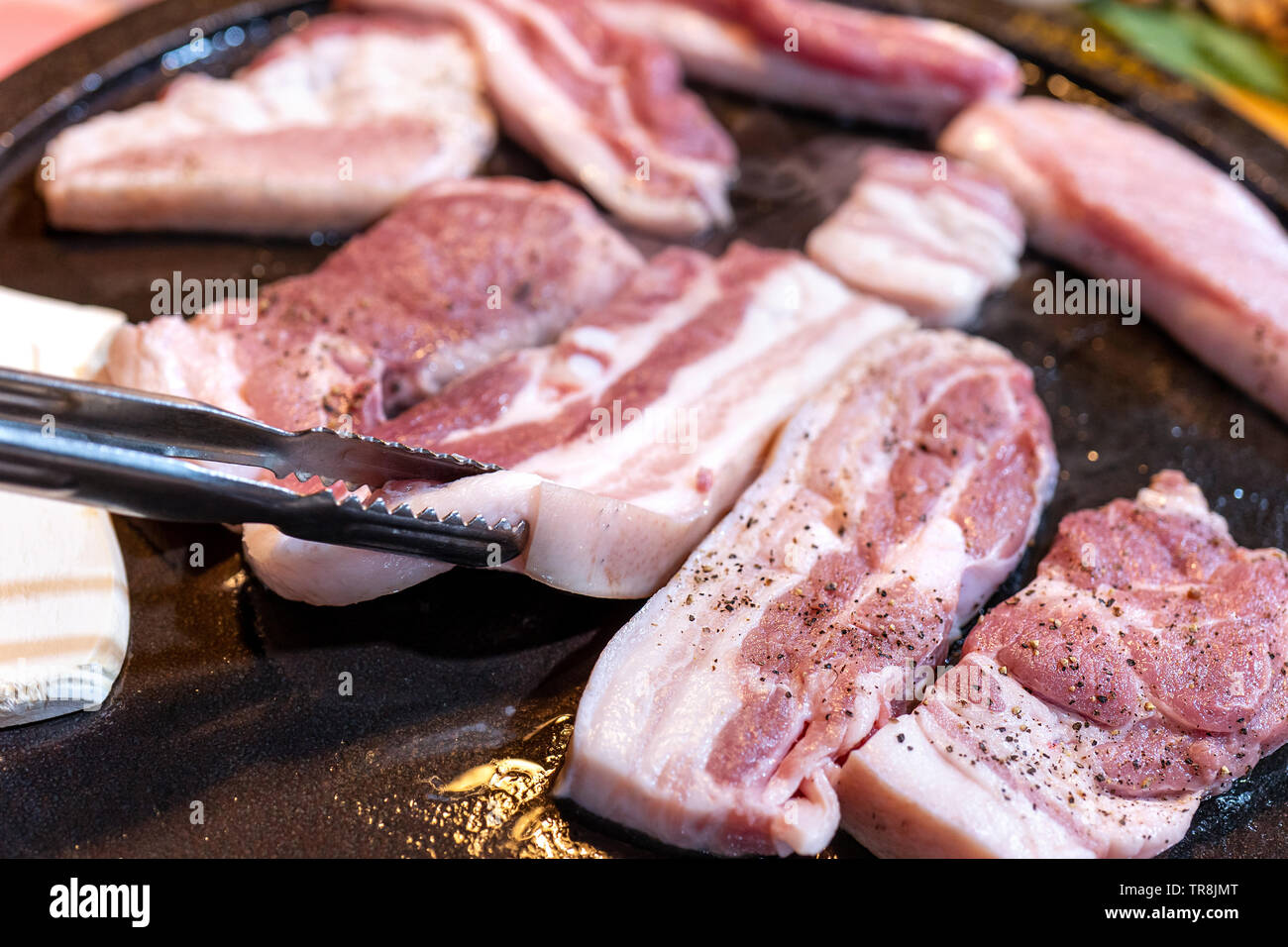 Panfried black pork meal in Korea restaurant, fresh delicious korean food cuisine on iron plate
