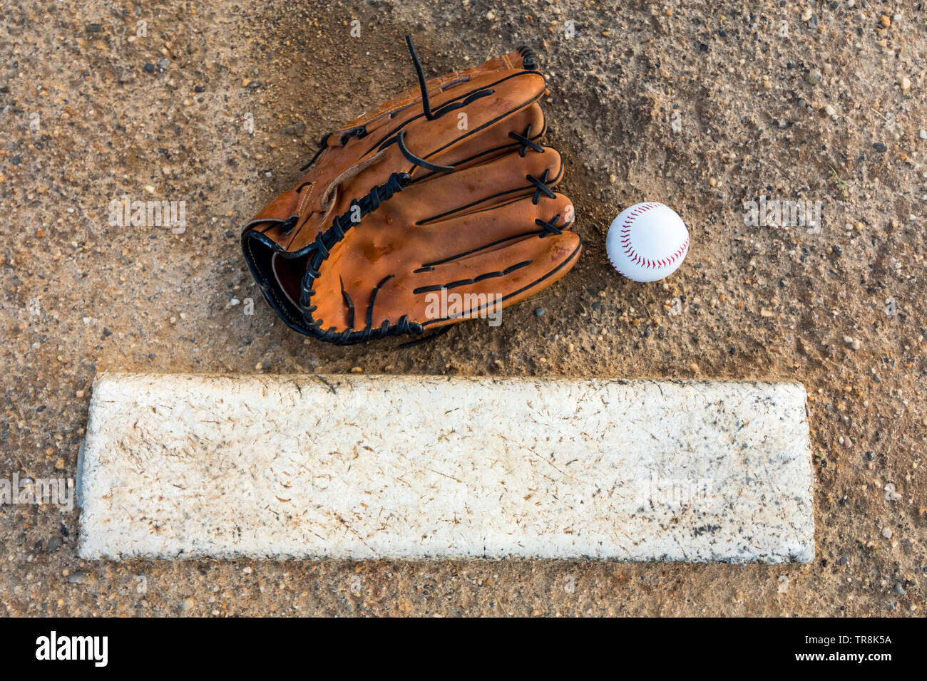 Baseball and glove on pitcher's mound flat lay Stock Photo - Alamy