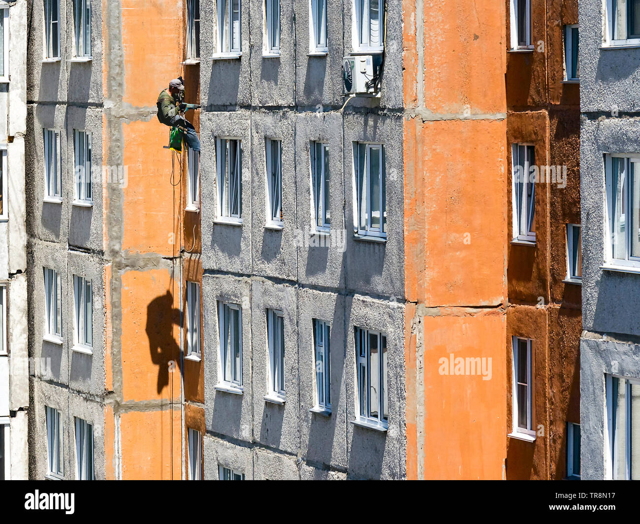 Maintenance Of Joints Between Precast Concrete Panels To Prevent Leakage Through The Wall Worker Climber Hanging On Ropes On A High Rise Building Fac Stock Photo Alamy