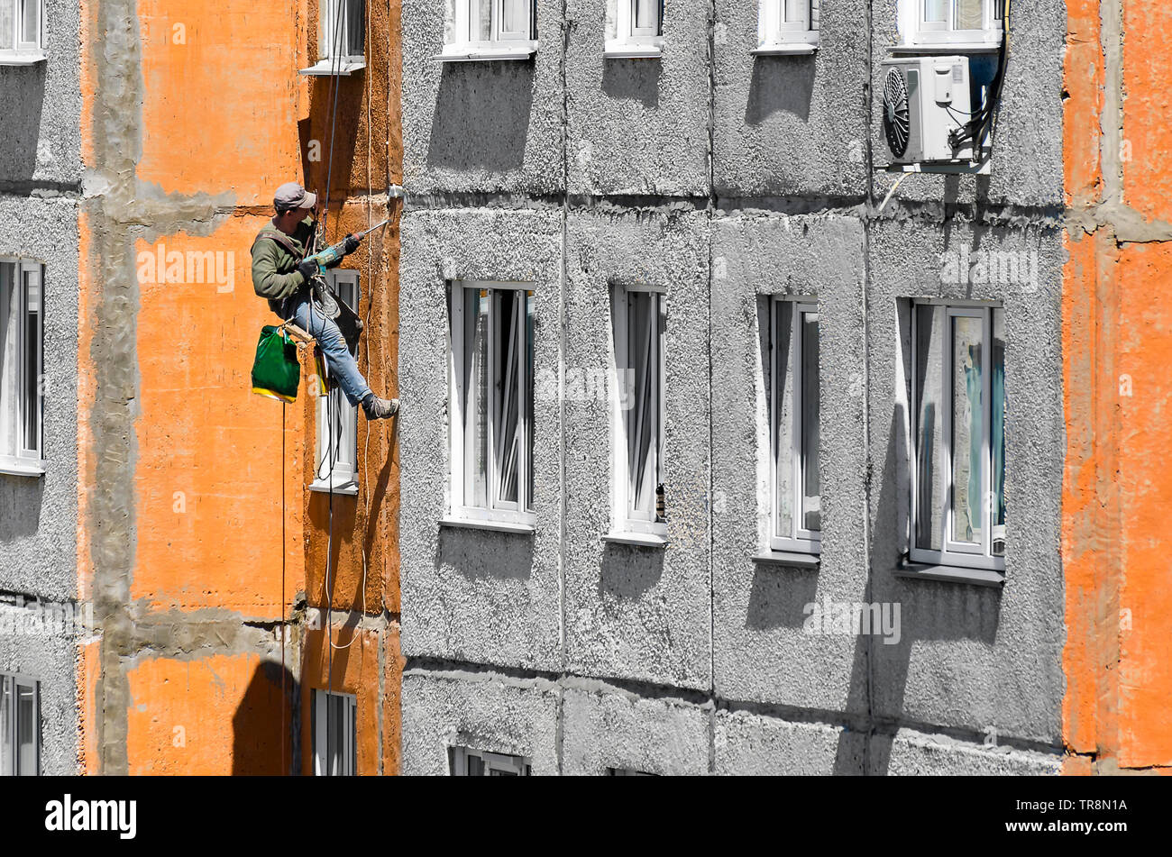 Maintenance Of Joints Between Precast Concrete Panels To Prevent Leakage Through The Wall Worker Climber Hanging On Ropes On A High Rise Building Fac Stock Photo Alamy