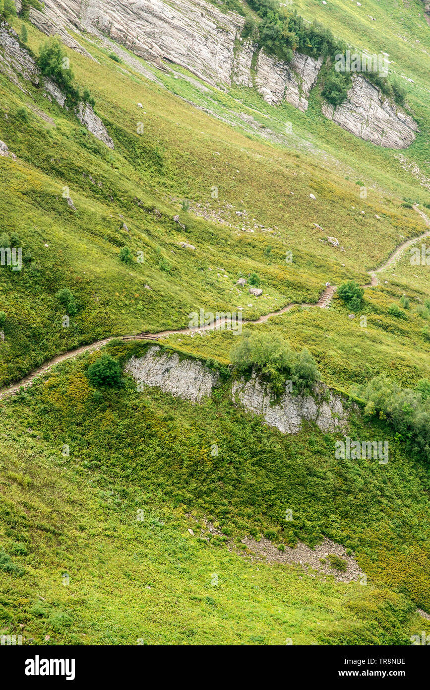 Hiking Trail in the Mountains. Aerial View. Green Alpine Meadows. Sochi. Russia. Krasnaya Polyana. Mountain Landscape. Stock Photo