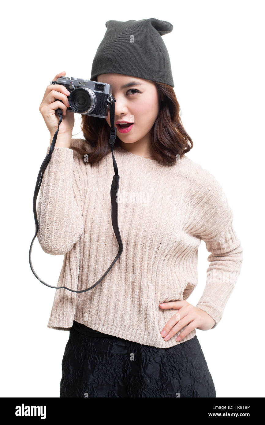 Happy young woman holding camera Stock Photo - Alamy