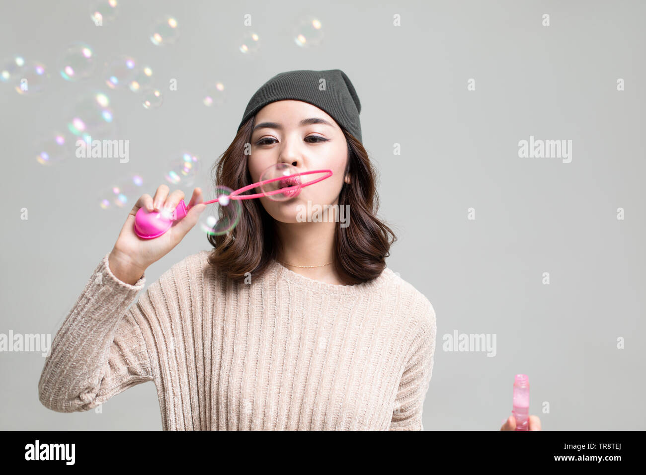 Young woman blowing bubbles Stock Photo - Alamy