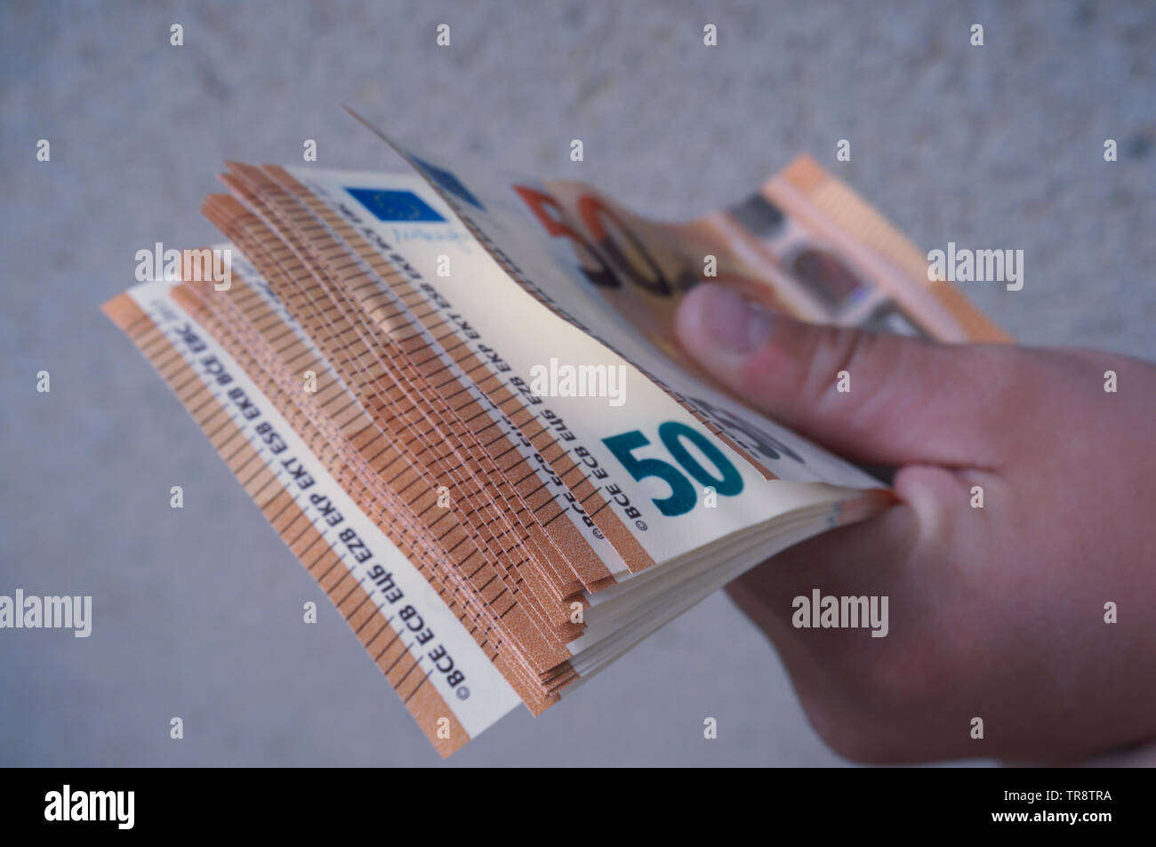 White Hand holding stack of fifty euros backnotes money close up Stock Photo
