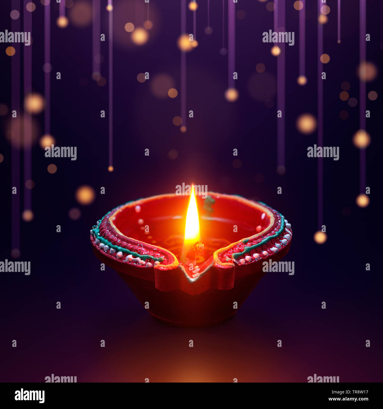 Diya oil lamp with hanging light background, Diwali celebration Stock Photo