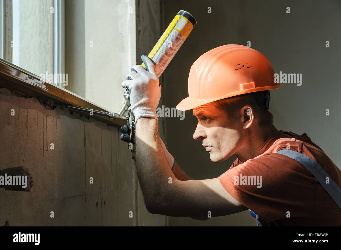 Worker is using a polyurethane foam for installation of window sill Stock  Photo - Alamy