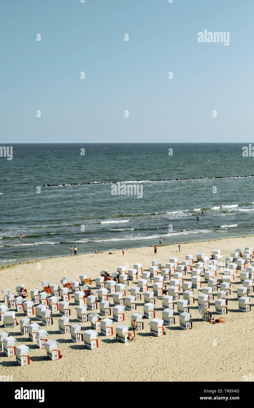 Typical German style beach deckchairs on the Baltic Sea coast of Rugen island northern Germany EU - regimented lines organised beach Stock Photo