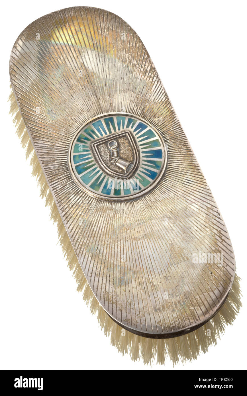 Hermann Göring - a clothes brush made by Professor Herbert Zeitner Natural hair bristles, silver mounting, coloured enamel. Ray-shaped engraving, enamelled medallion with superimposed family coat of arms. Master's monogram 'HZ', mark of fineness '925'. Length 19.5 cm. Professor Zeitner was Göring's favourite jeweller. Numerous objects for the personal use of the Reichsmarschall as well as many jeweller's pieces bestowed as gifts by Göring originated in his workshop. historic, historical, 20th century, 1930s, NS, National Socialism, Nazism, Third Reich, German Reich, Germany, Editorial-Use-Only Stock Photo