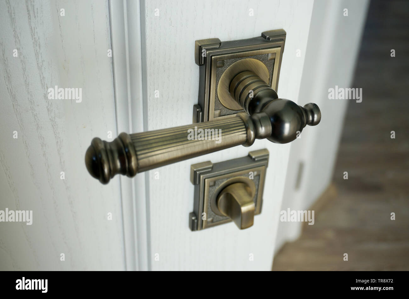 Metal door handle and lock on white door close up Stock Photo - Alamy