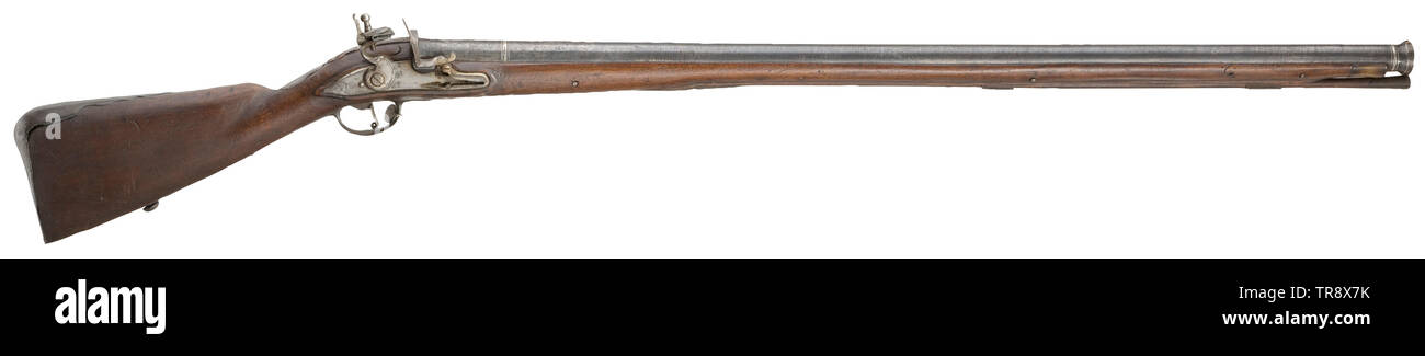 Traditional kentucky rifle and a gunpowder horn on an old, damaged board  Stock Photo
