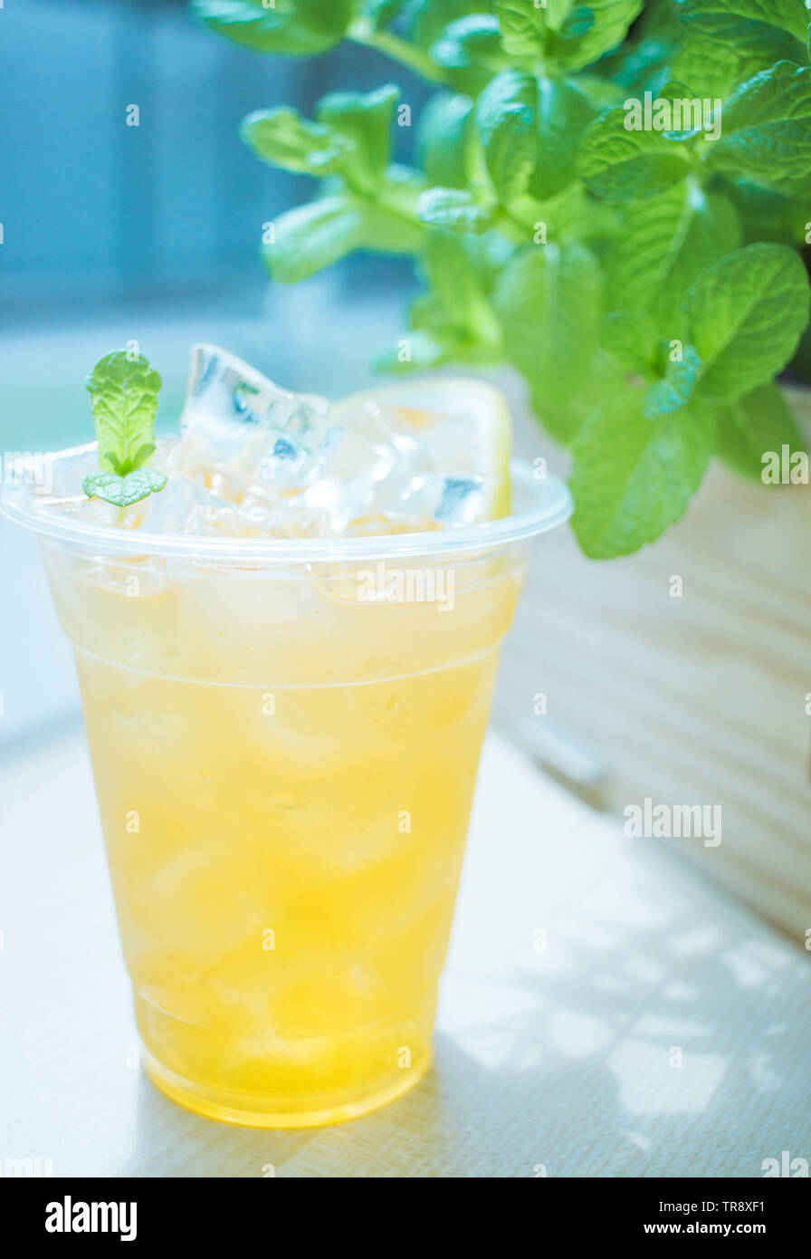 Black tea lemonade, lots of ice and a slice of lemon.In the background