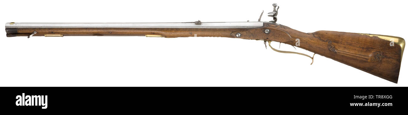 A German flintlock rifle, circa 1780 Rifled, octagonal barrel in 15.5 mm calibre. Sparsely chiselled flintlock. Set trigger. Walnut full stock with brass furniture, carved patch-box lid and horn nose. Behind the trigger guard a stamp with the coat of arms of the Salm-Reifferscheidt family as well as the number '53'. Wooden ramrod with horn tip. The iron parts reworked and partially pitted. Length 109 cm. historic, historical, civil long guns, gun, weapons, arms, weapon, arm, Additional-Rights-Clearance-Info-Not-Available Stock Photo