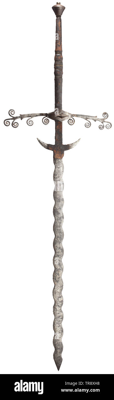 A two-handed flamberge, a high-grade collector's reproduction in the style of the 16th century Wavy blade with downcurved guards, above the guards on one side an etched coat of arms and the date 1597, on the other the image of a warrior and floral ornaments. Ricasso with remains of leather cover. Extended cross-guard with volute ornaments, symmetrical side rings and guard plates within. Leather-covered grip with wire winding. Conical pommel with small riveted finial. Length 176 cm. Decorative replica, true to original. historic, historical, sword, Additional-Rights-Clearance-Info-Not-Available Stock Photo