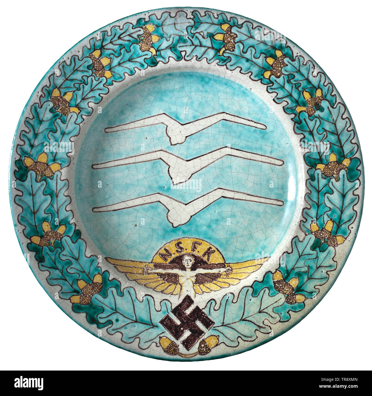 A large hand-painted wall plate Glazed stoneware. Coloured underglaze painting with NSFK (National Socialist Flyers Corps) symbols within an oak leaf wreath. Underglaze inscription 'Stüdemann Thurnau' on the reverse side. Glaze with craquelure. Diameter 38.5 cm. Rare. historic, historical, organisation, organization, organizations, organisations, 20th century, Additional-Rights-Clearance-Info-Not-Available Stock Photo