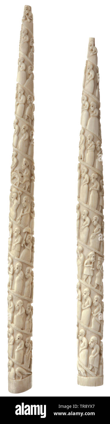A pair of carved elephant tusks, West Africa, mid-19th century Small elephant tusks with carved spiral friezes of figures in high relief. Most of the figures depicted probably representing slaves, interspersed with guards with rifles, African traders and Europeans. The eyes coloured black. Slightly knocked in places. Length 55.5 and 49 cm. Provenance: From old North German family possessions, reportedly a wedding gift to a captain of the merchant navy from his great-great-grandparents as early as 1842. historic, historical, Africa, African, weapo, Additional-Rights-Clearance-Info-Not-Available Stock Photo