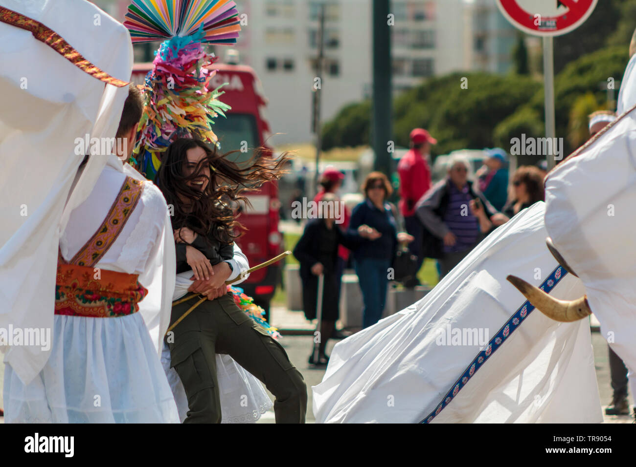 Lisbon, Portugal: 18 May 2019: Masked men rattles young at the Iberian Mask Festival Stock Photo