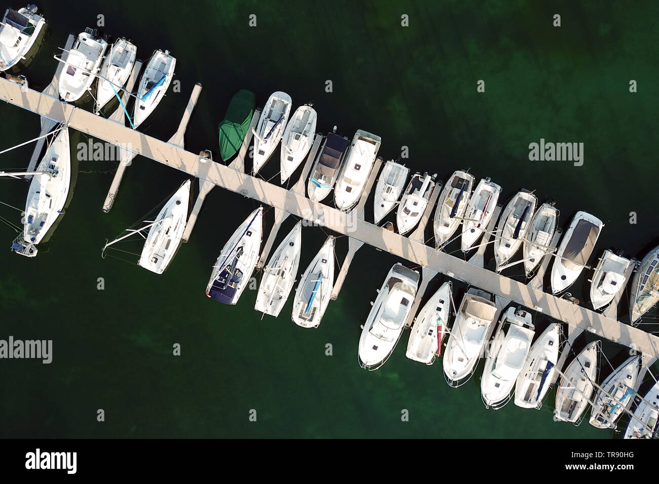 Aerial drone image of a marina populated with recreational boats and yachts in Yvoire, France on Lake Geneva (Leman). Stock Photo