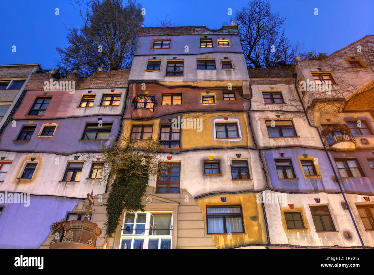 Facade at night of the famous architectural landmark Hundertwasserhaus in Vienna, Austria Stock Photo