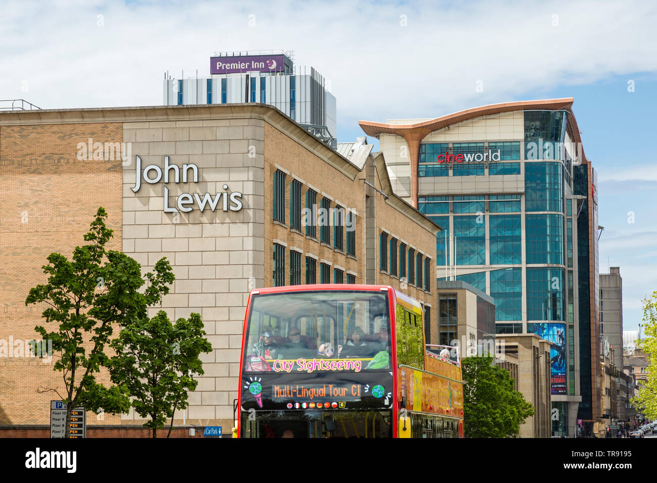 Glasgow city centre tour bus passing John Lewis, Cine World and Premier