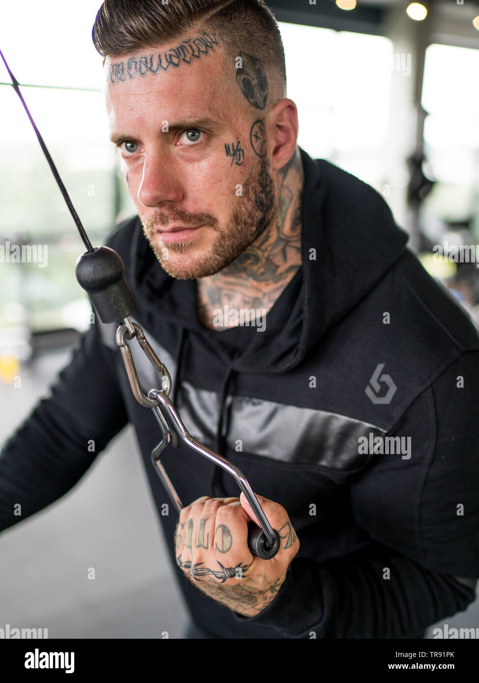 Man with Tattoos Builds Power and Pride