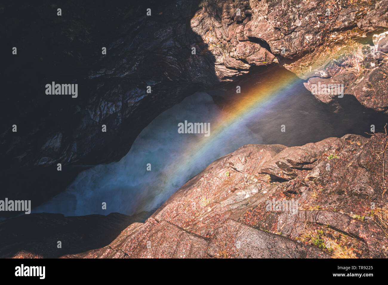 Rainbow over waterfall called Gudbrandsjuvet in Norway. Valldola river in Valldal valley. Stock Photo