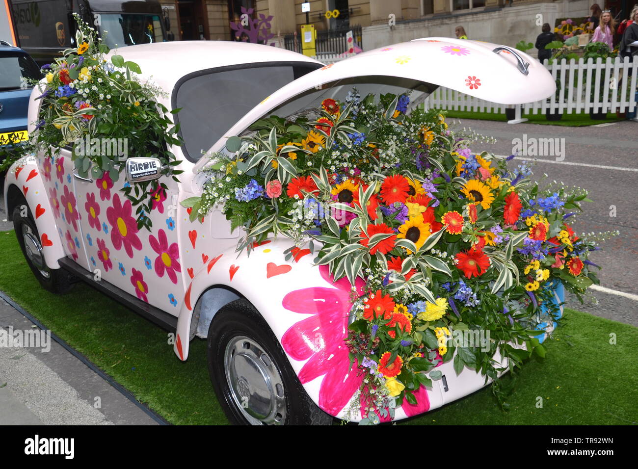 The Manchester Flower Show, part of Manchester's King Street  Festival on June 1st - 2nd, 2019, prepares to open. This year’s theme:Flower Power! Retro objects, like this Volkswagen beetle car, feature in the festival. Stock Photo