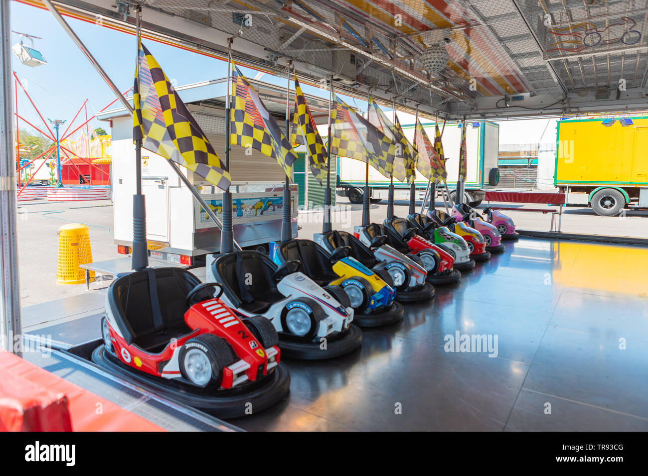 Bergamo, Italy - May 2019: Small colored bumper cars for children with flags in an Italian park during a fair. Spring, beautiful day, vibrant. Stock Photo