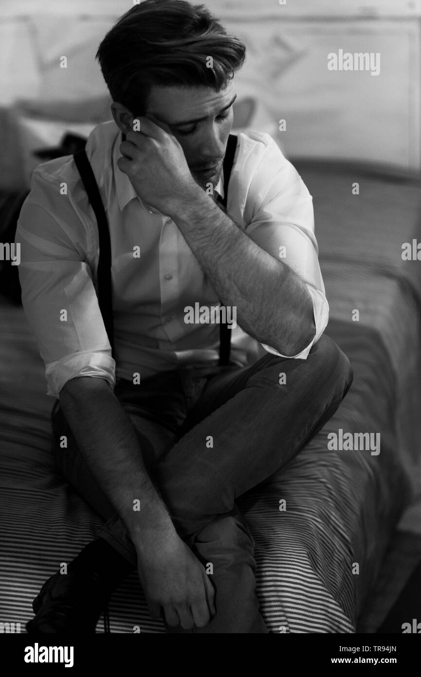 men sitting on bed Stock Photo - Alamy