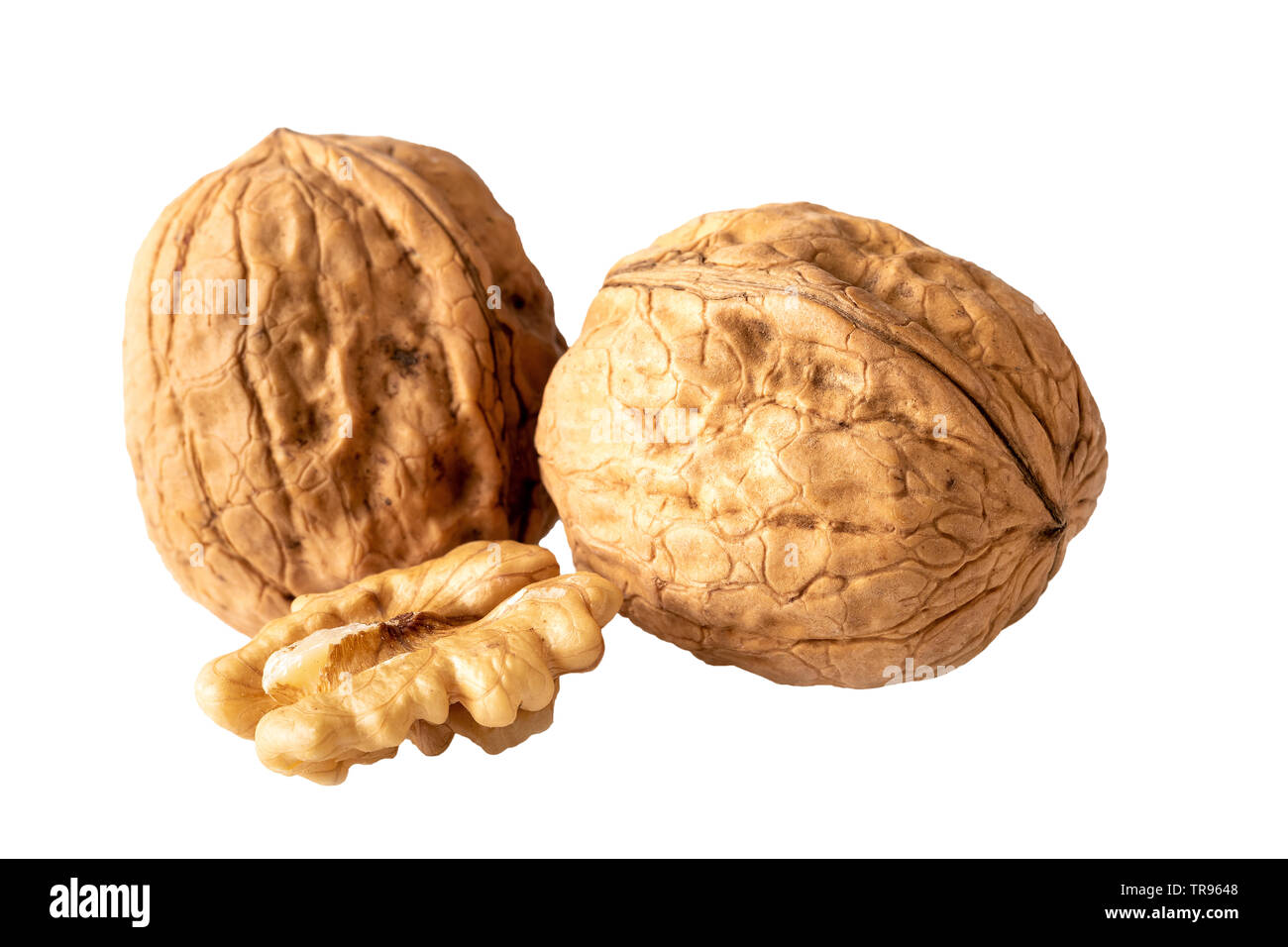 two unshelled walnuts and walnut halve isolated on white Stock Photo