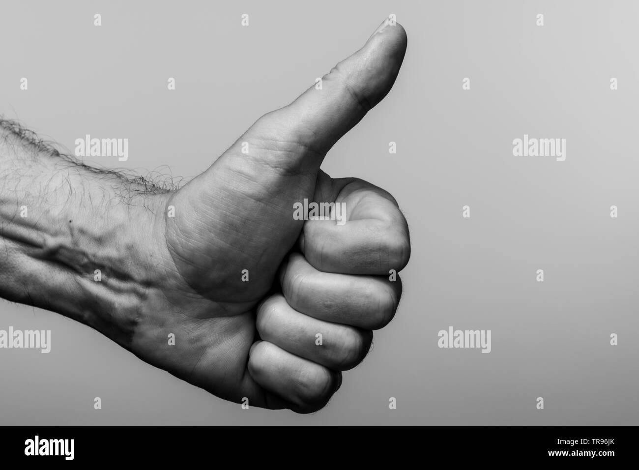 Close up of a mans hand, thumbs up gesture. Stock Photo