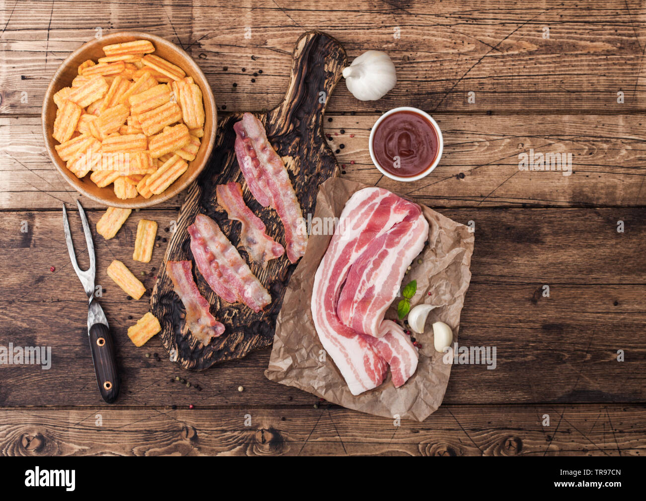 Bacon flavored snacks chips with grilled bacon rashers on vintage