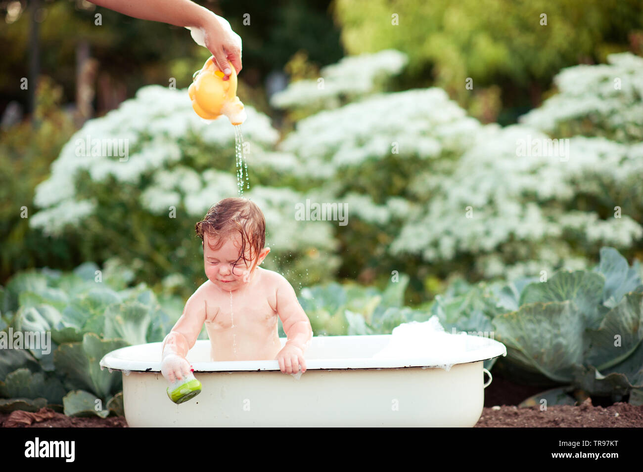 Baby girl bathing outdoors. Childhood Stock Photo - Alamy