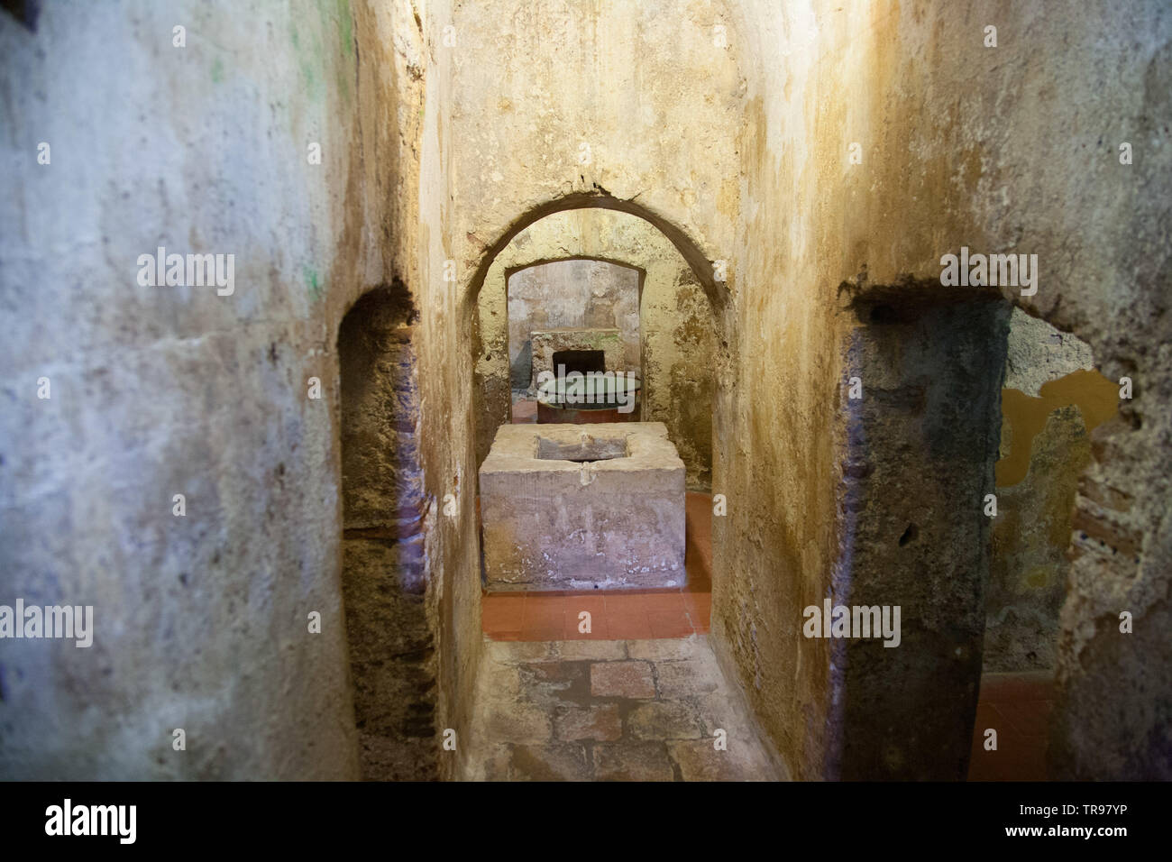 Underground chambers of the 4th/5th century hypogeum under the church of san salvatore in Sinis, Sardinia with altar in the background Stock Photo