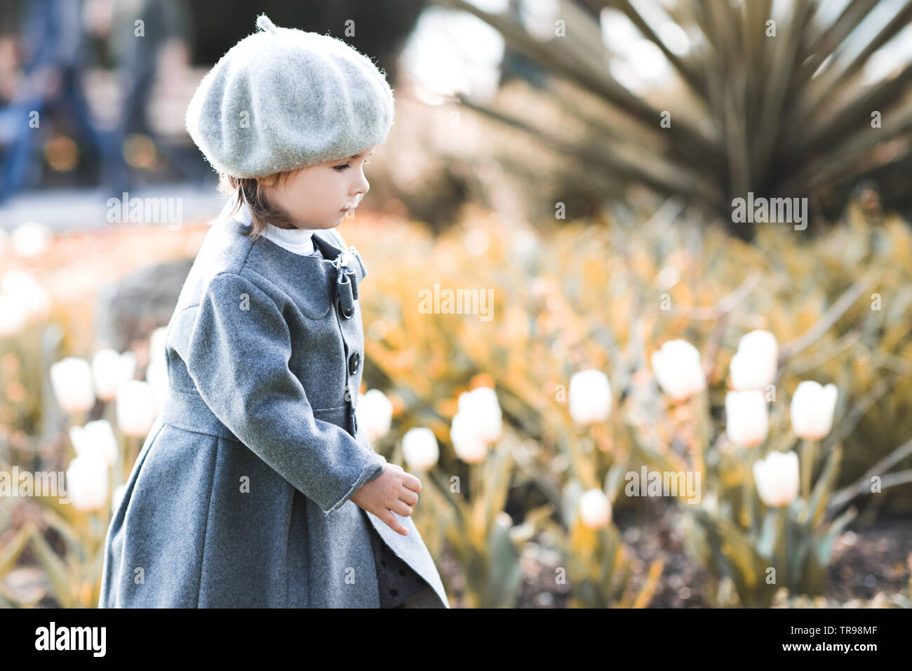 Cute kid girl 1-2 year old wearing stylish clothes over city background.  Looking at camera. Childhood Stock Photo - Alamy