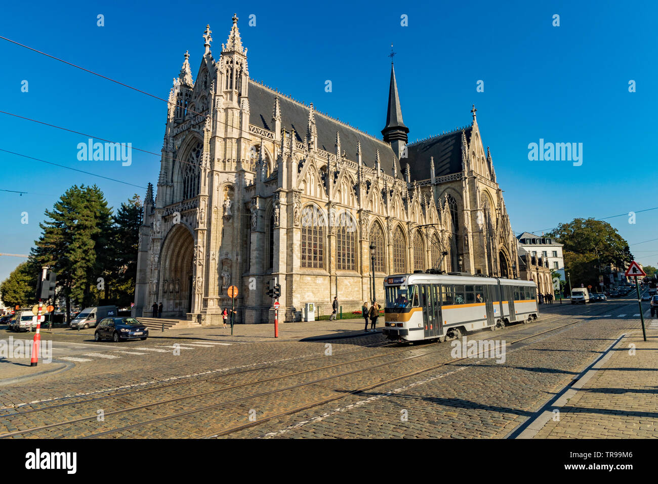 A tram passes in front of Church of Notre Dame du Sablon , A Gothic style church near Sablon Square, Brussels , Belgium Stock Photo