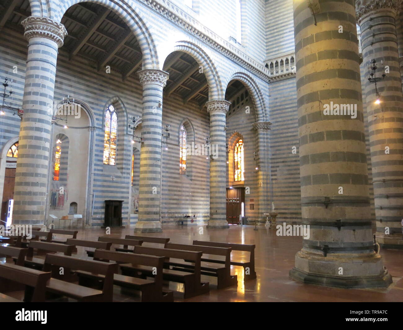 Alternate rows of basalt and travertine create a black & white striped effect on the interior columns of the 14th century cathedral at Orvieto, Italy Stock Photo