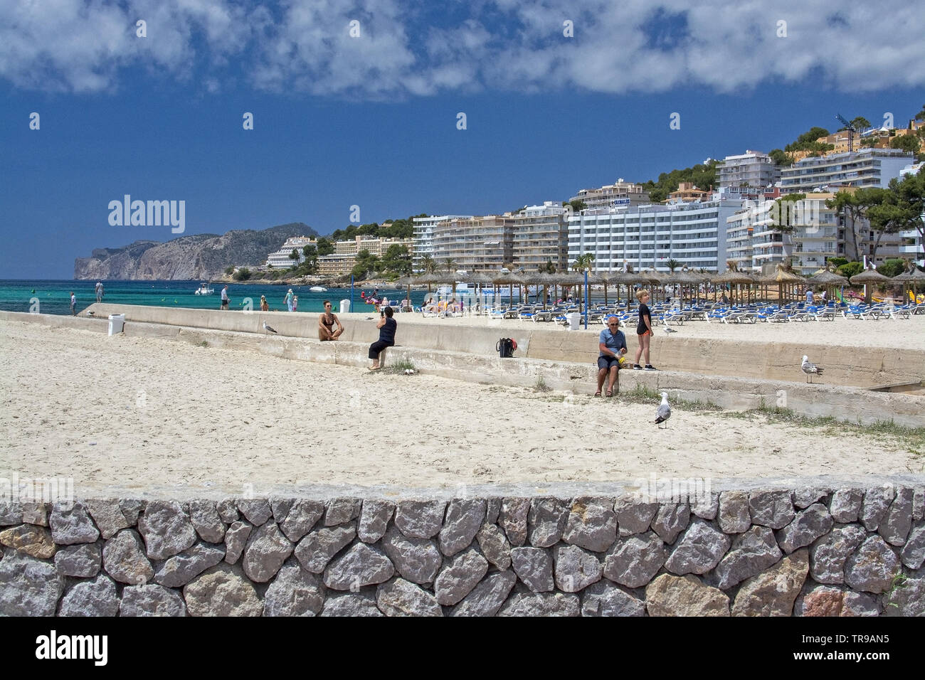 SANTA PONSA, MALLORCA, SPAIN - MAY 29, 2019: Sandy beach on a sunny day with people May 29, 2019 in Santa Ponsa, Mallorca, Spain. Stock Photo