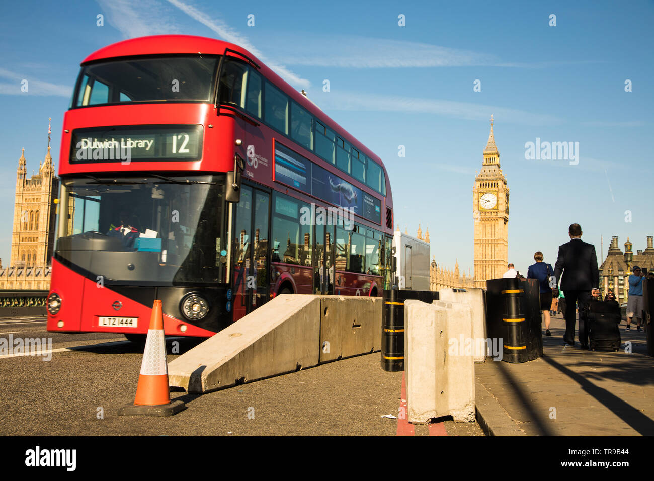 London Bus on Westminster Bridge passing anti vehicle barriers Stock Photo