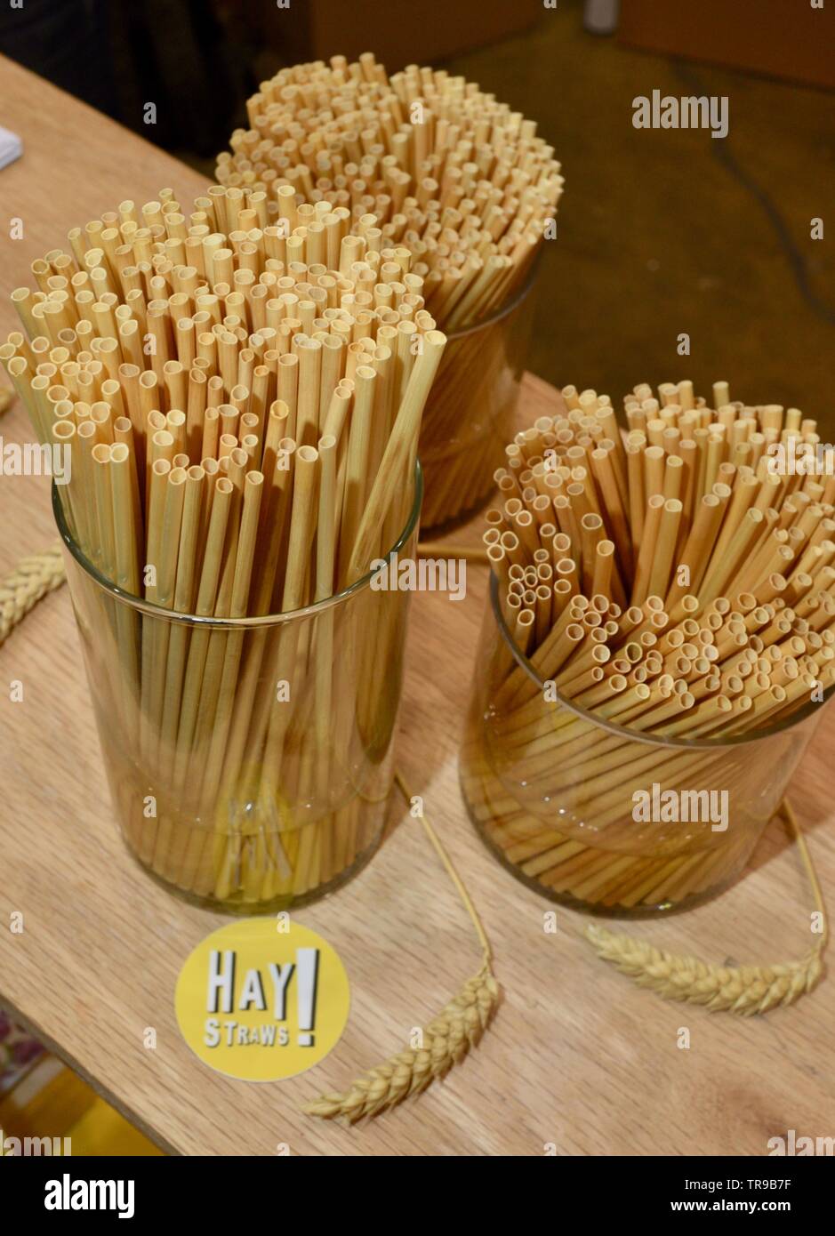 Assorted natural straws made from wheat stalks in jars on display at Hay Straw booth at National Restaurant Association Show held in Chicago, IL, USA Stock Photo