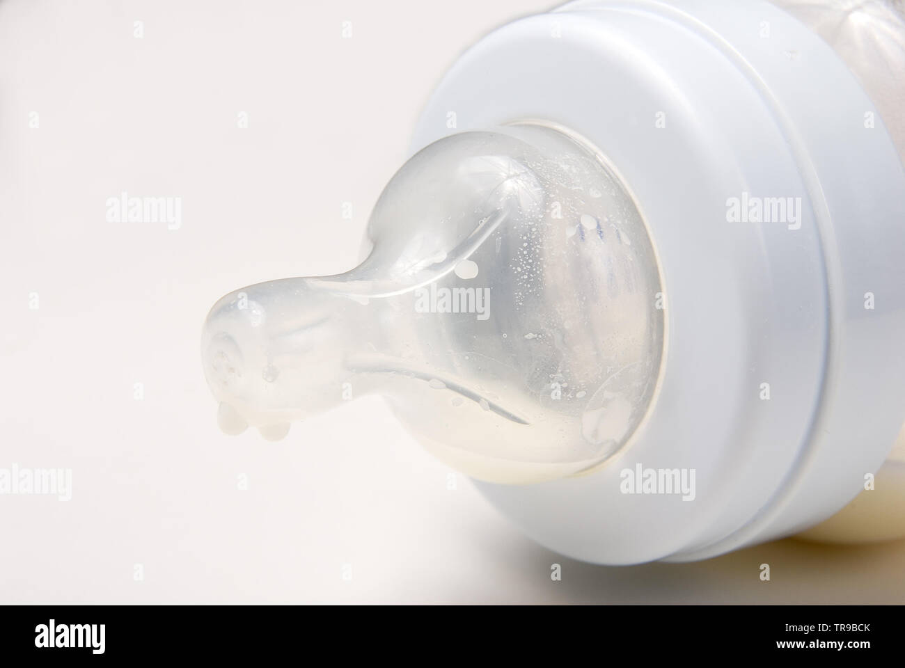 close-up of milk drops on a baby feeding bottle teat Stock Photo