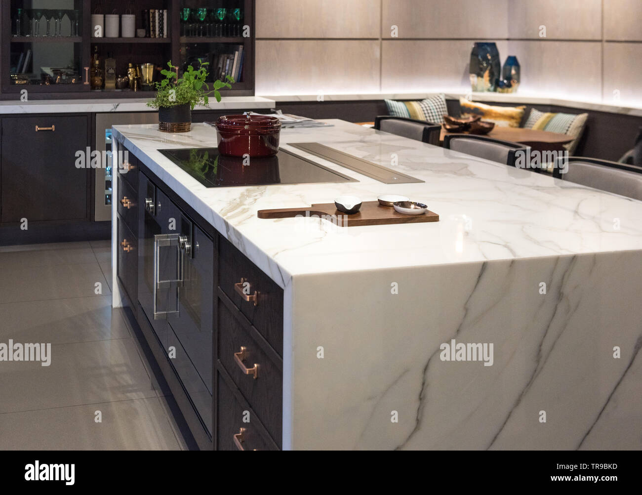 Marble Top Kitchen Island with Ceramic Bowls on wooden board Stock