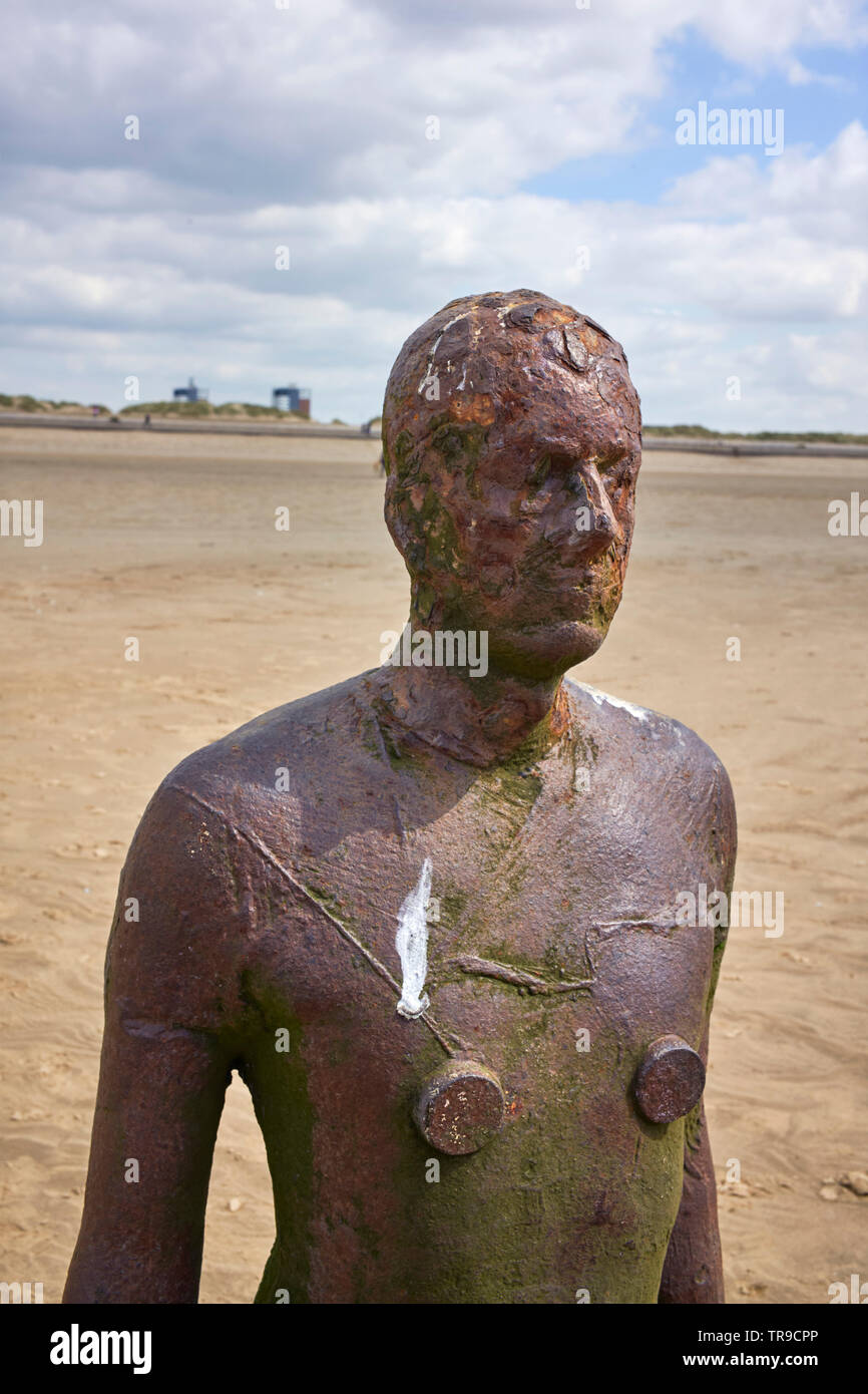 One of Anthony Gormley’s statues ‘Another Time’ set into the sand at Crosby beach, Merseyside Stock Photo