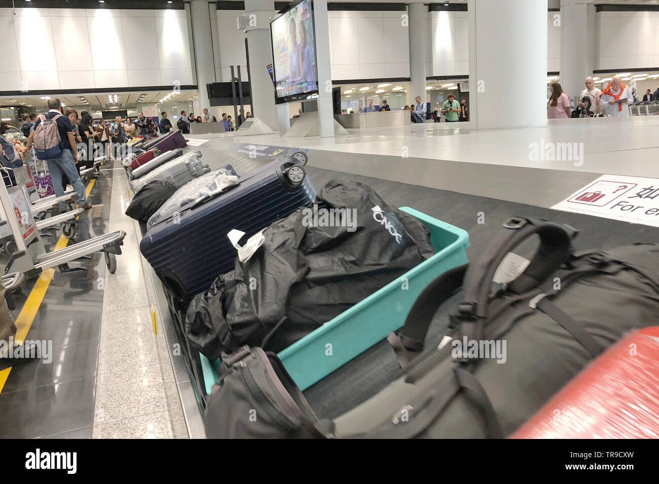 Luggage conveyor belt with personal suitcases moving around circle
