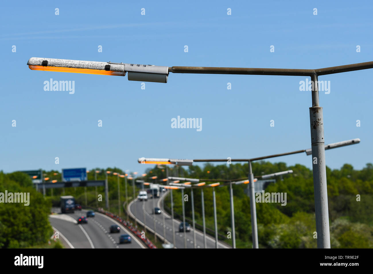 street lights on the a42 left on during the day Stock Photo