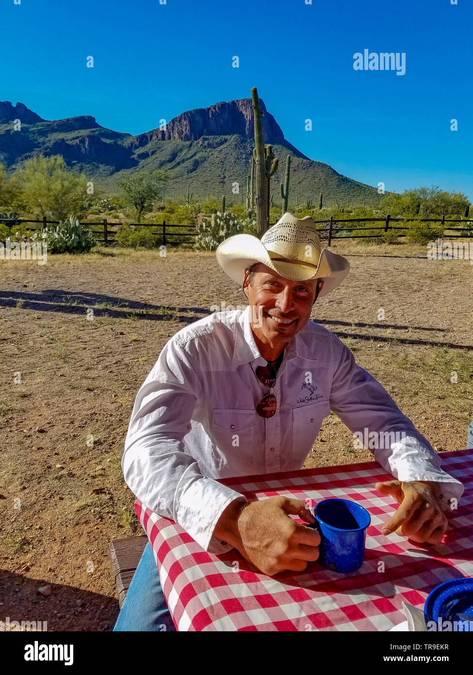 A ranch wrangler eats breakfast during the breakfast ride at White Stallion Ranch, a dude ranch just outside Tucson, AZ. Stock Photo