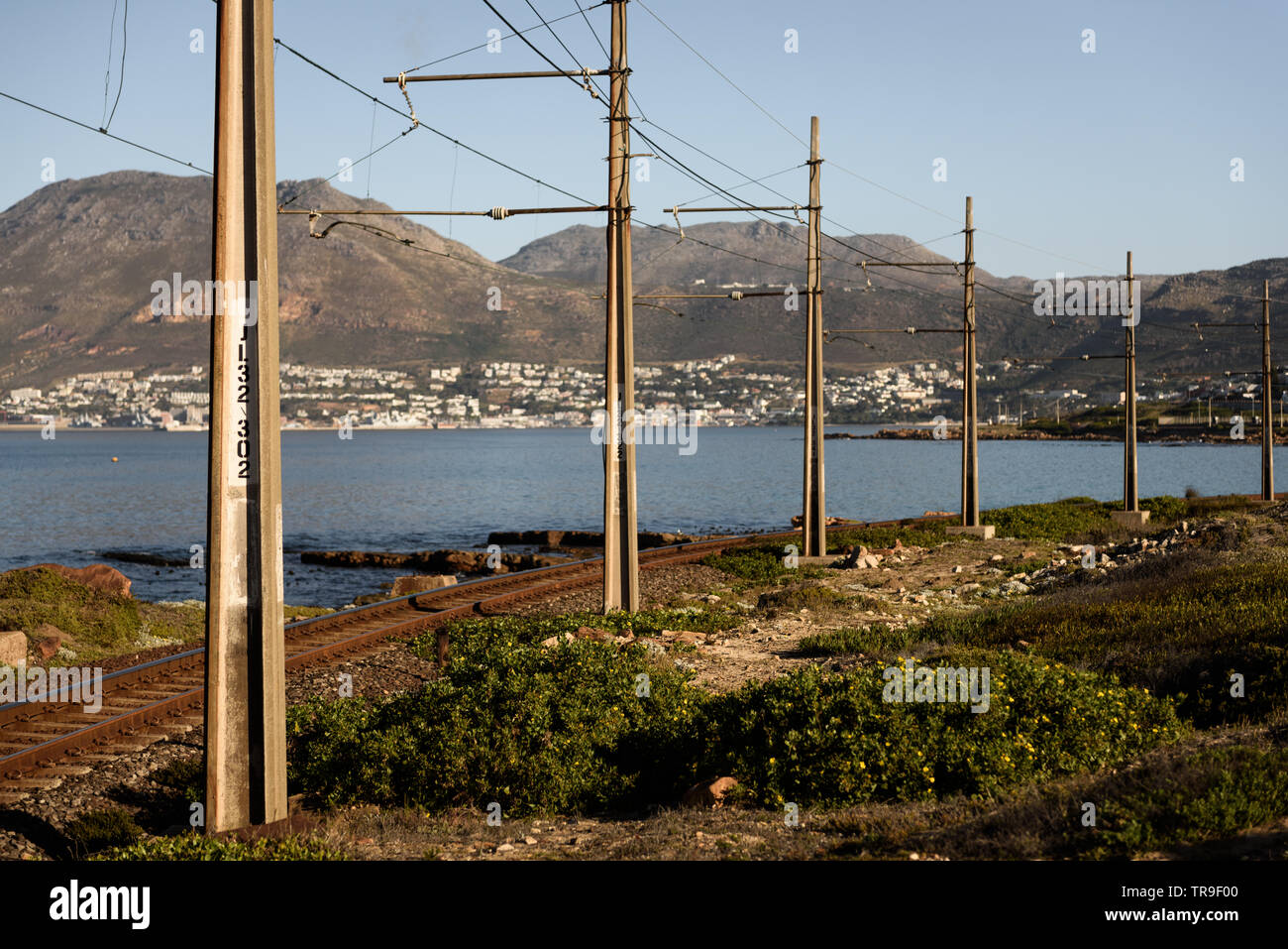 The railway between Muizenberg and Simons Town follows the False Bay coastline on the Cape Peninsula, near Cape Town, in South Africa Stock Photo