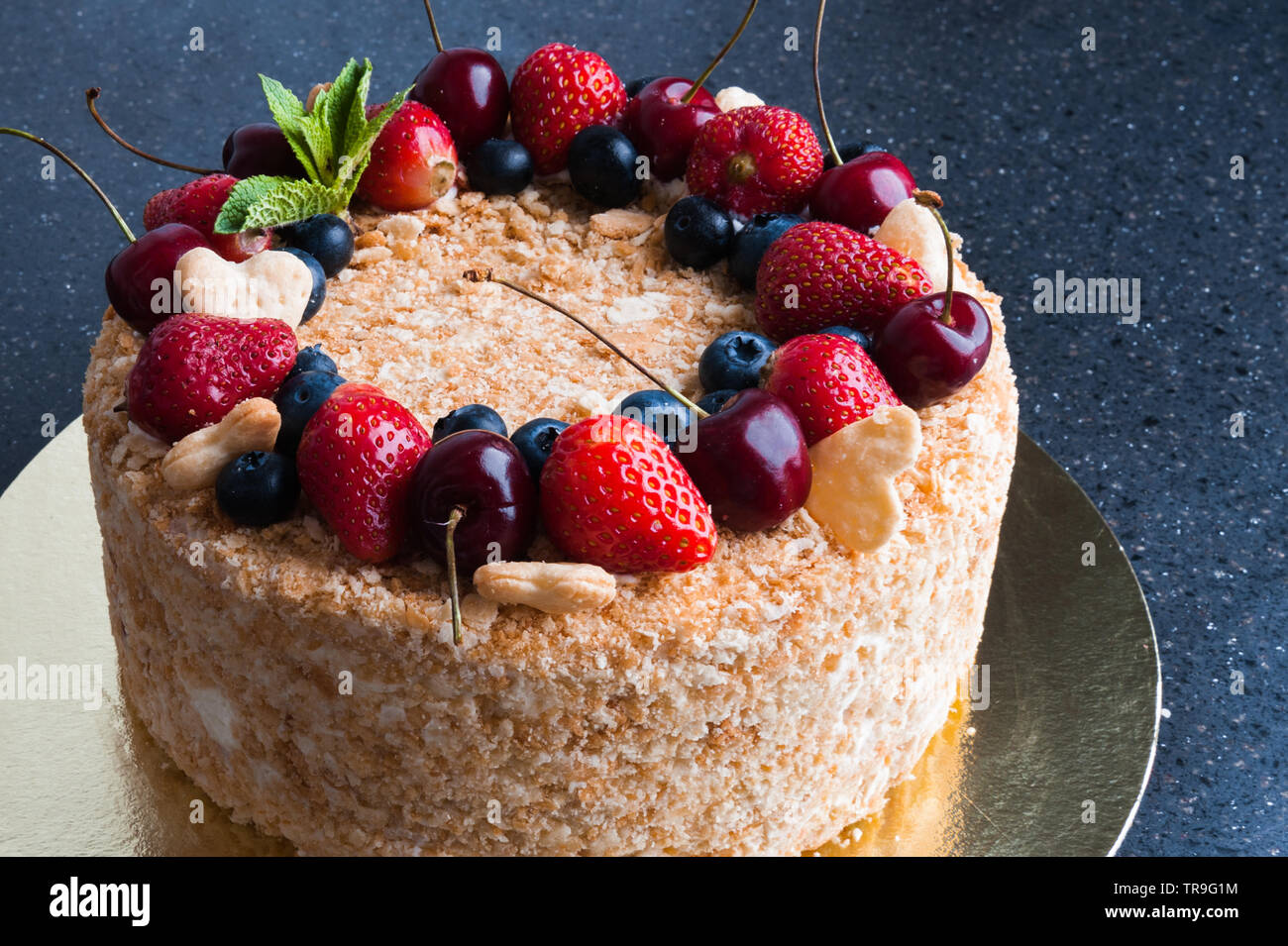 sponge cake with berries on dark background Stock Photo