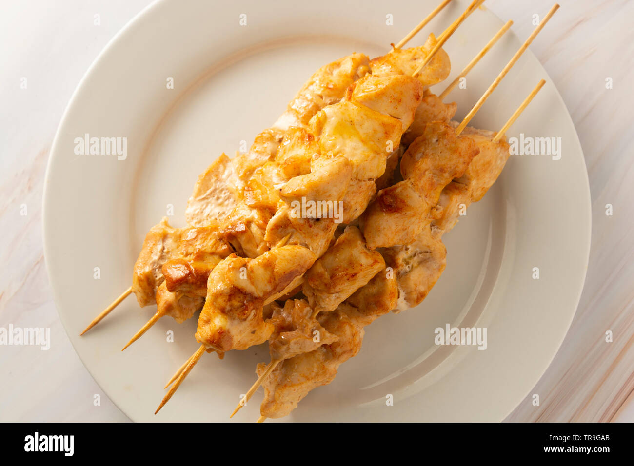 Chicken meat on bamboo skewers in white plate, marble bright background,  diet low fat food Stock Photo - Alamy