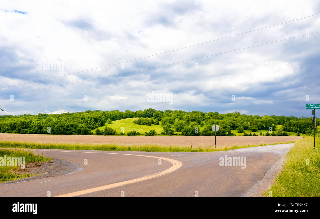 Beautiful view of rural Missouri in spring with hills, roads and sky Stock Photo